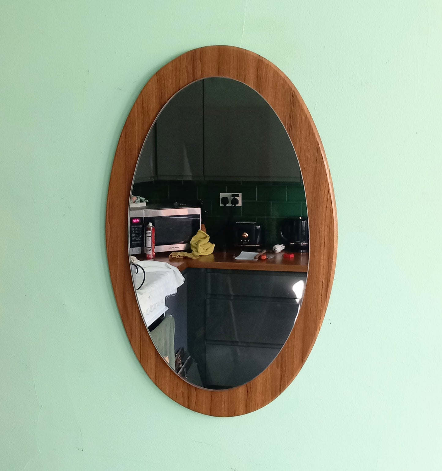 Mid century 1970s teak wood effect backed oval wall mirror 23"