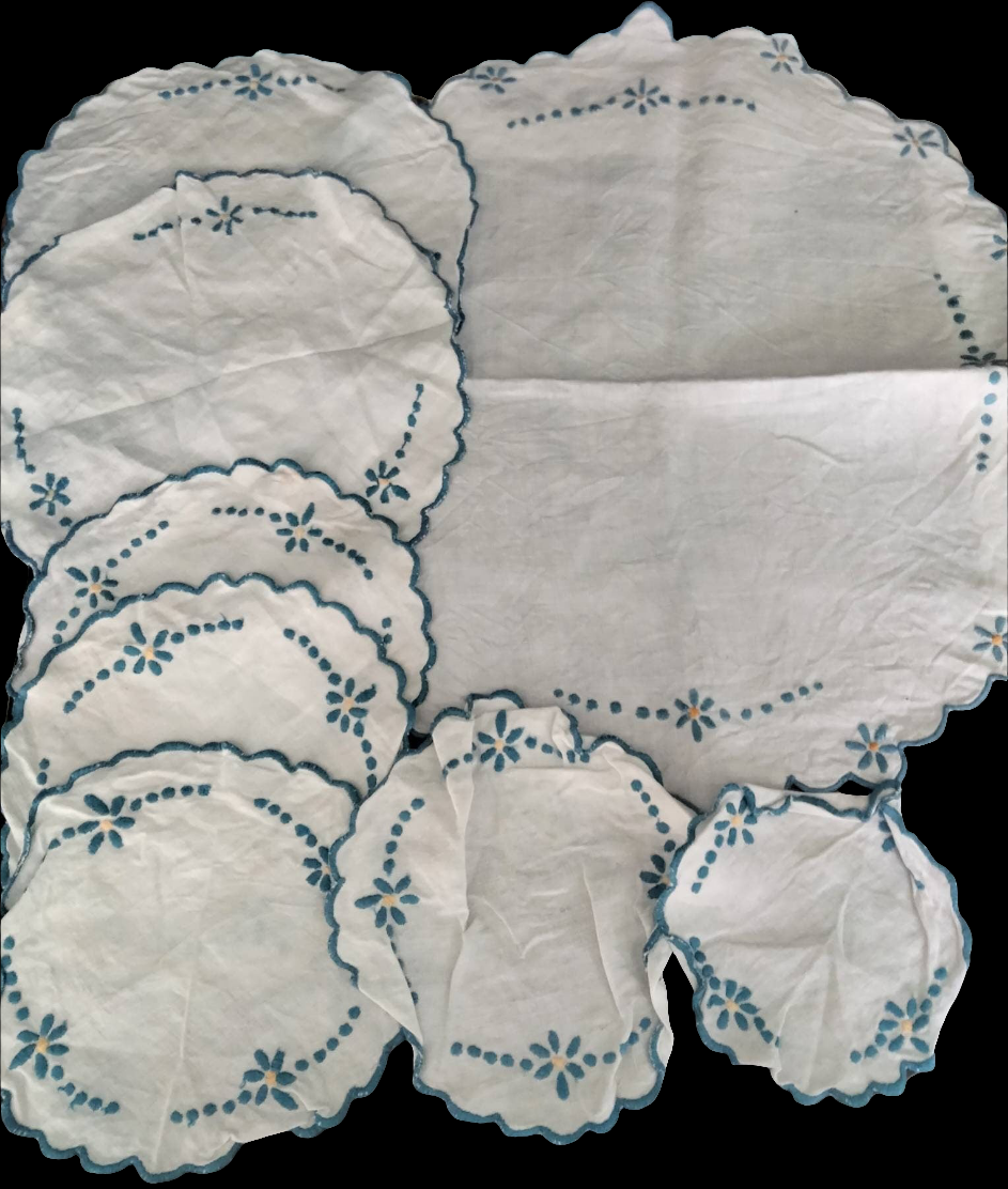 Set of 8 mid century hand made embroidered doilies with blue flowers