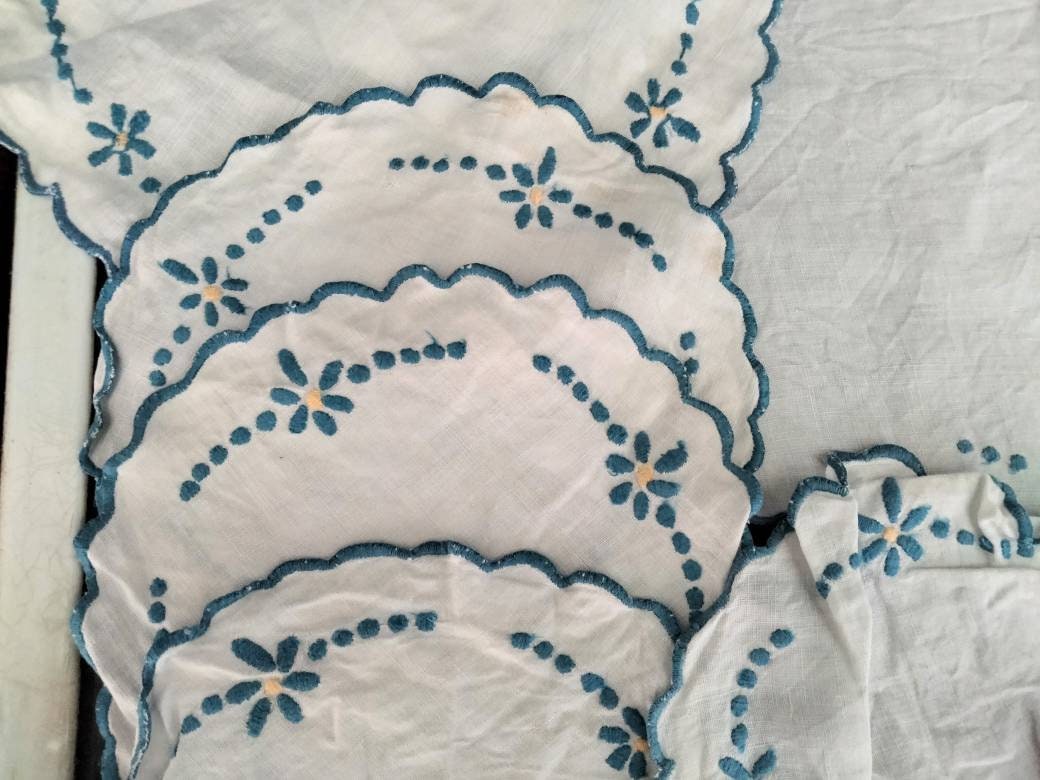 Set of 8 mid century hand made embroidered doilies with blue flowers