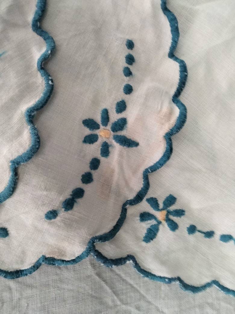Set of 8 mid century hand made embroidered doilies with blue flowers