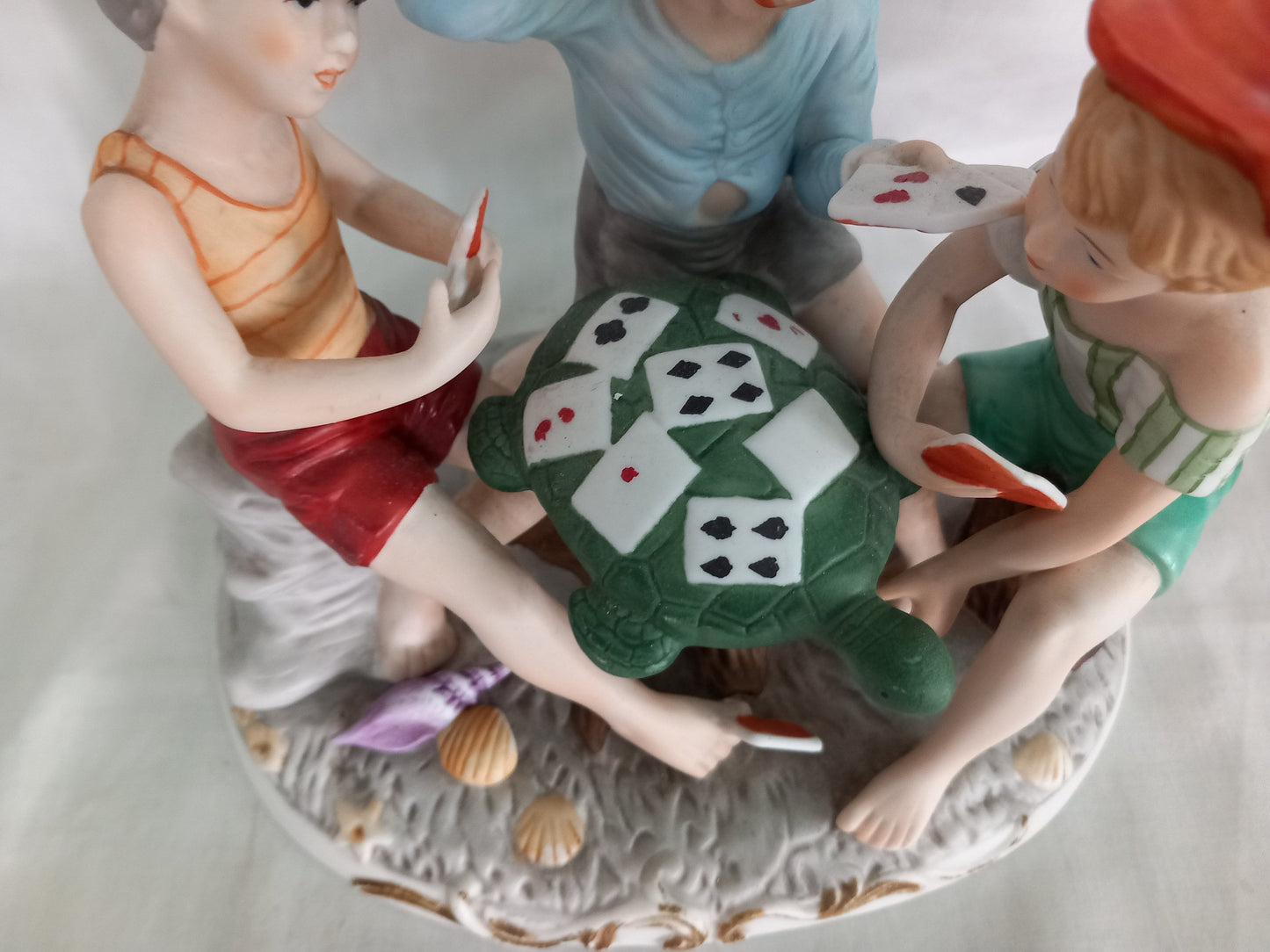 Vintage kitsch ceramic figurine statue Of 3 Boys Playing Cards On A Turtle