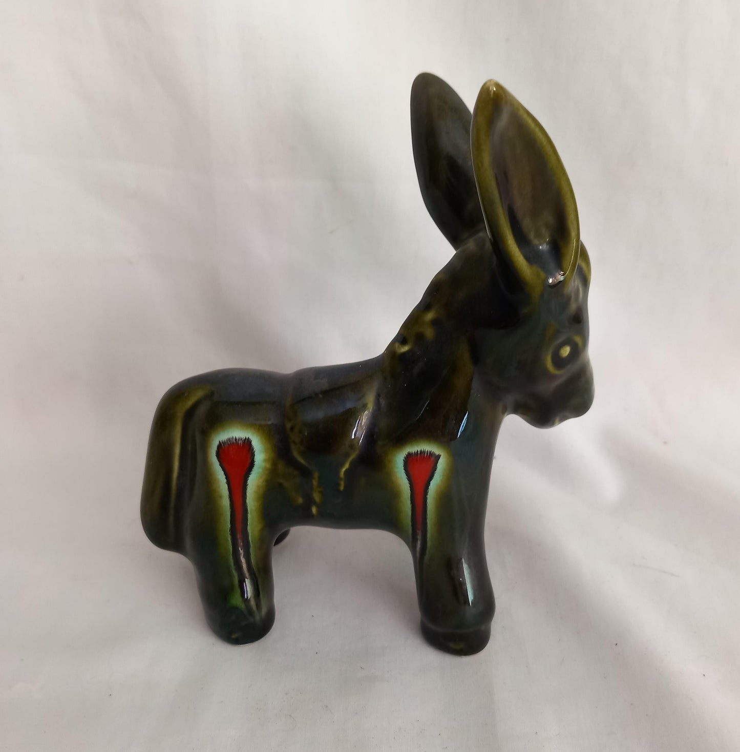 Mid century green and red lava glaze donkey statue