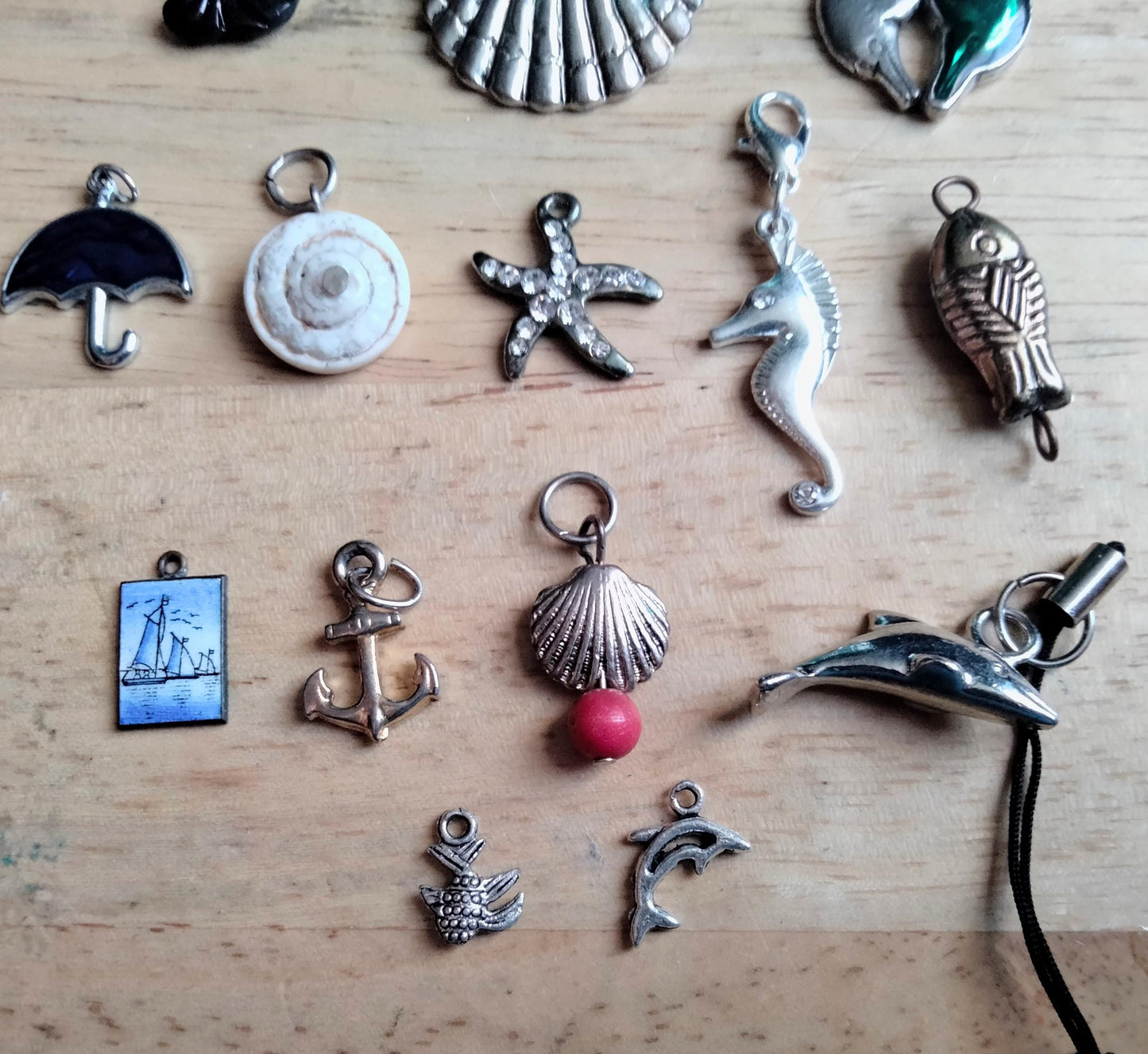 Lot of 14 seaside and sealife pendants and charms including fish, shells, anchor and starfish