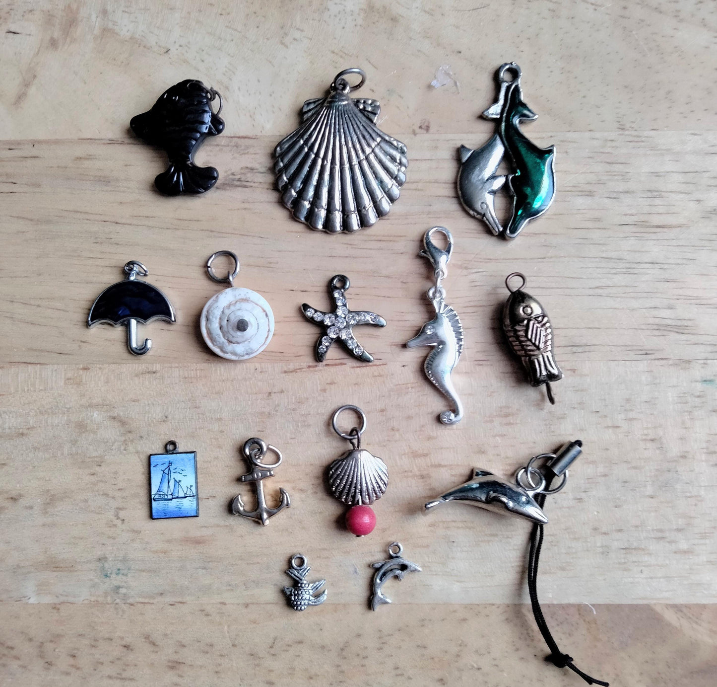 Lot of 14 seaside and sealife pendants and charms including fish, shells, anchor and starfish