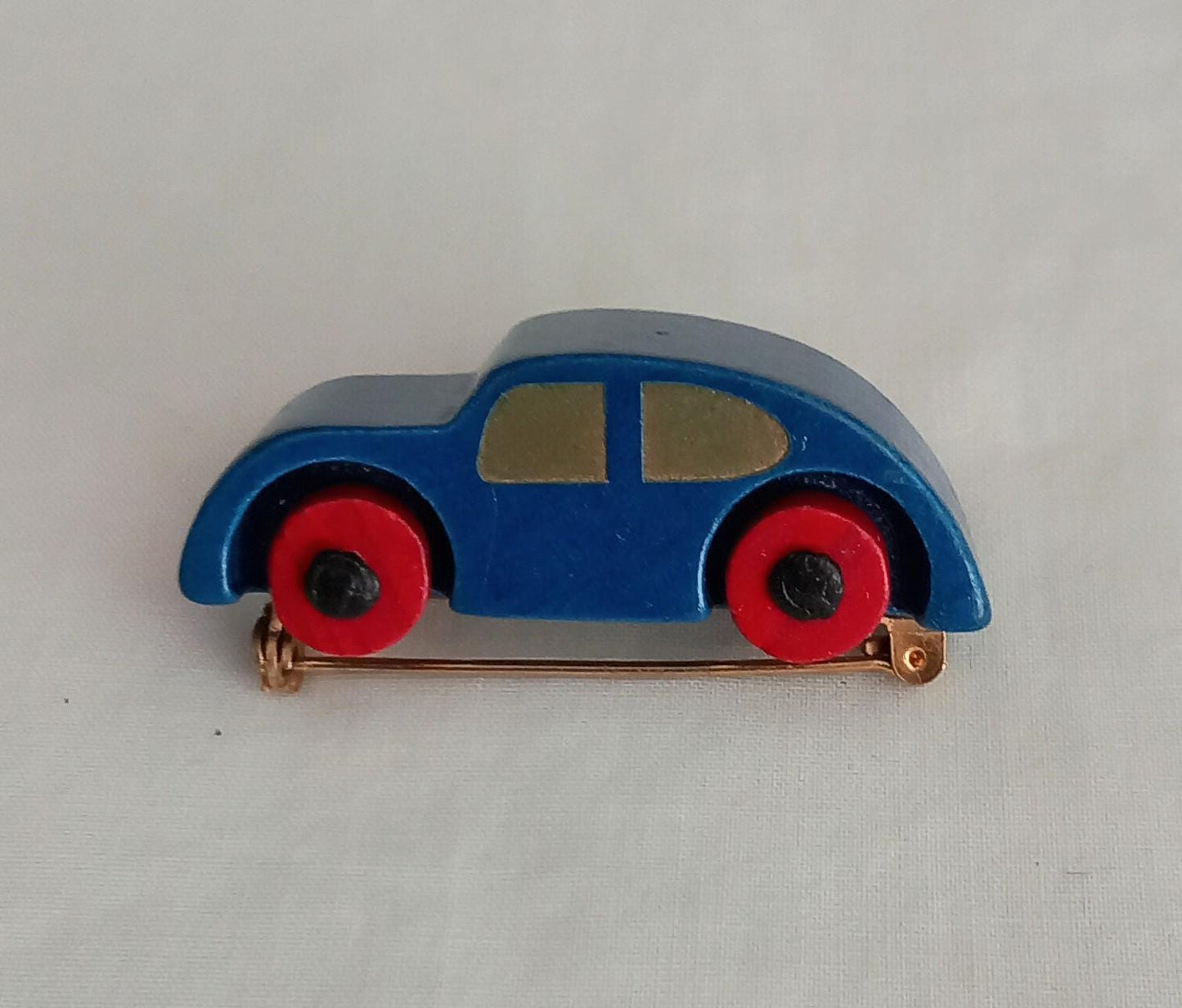 1960s hand made blue & red wooden car brooch with moving wheels