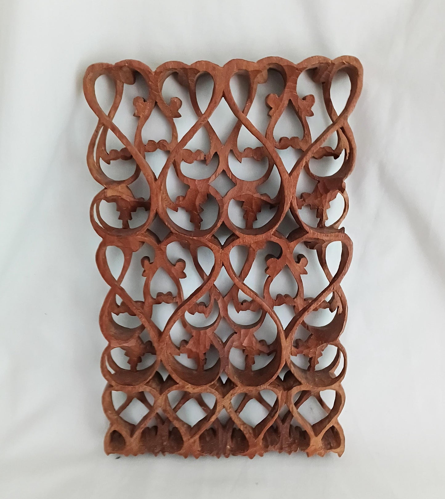 Intricately carved ethnic wooden curved pattern wall plaque