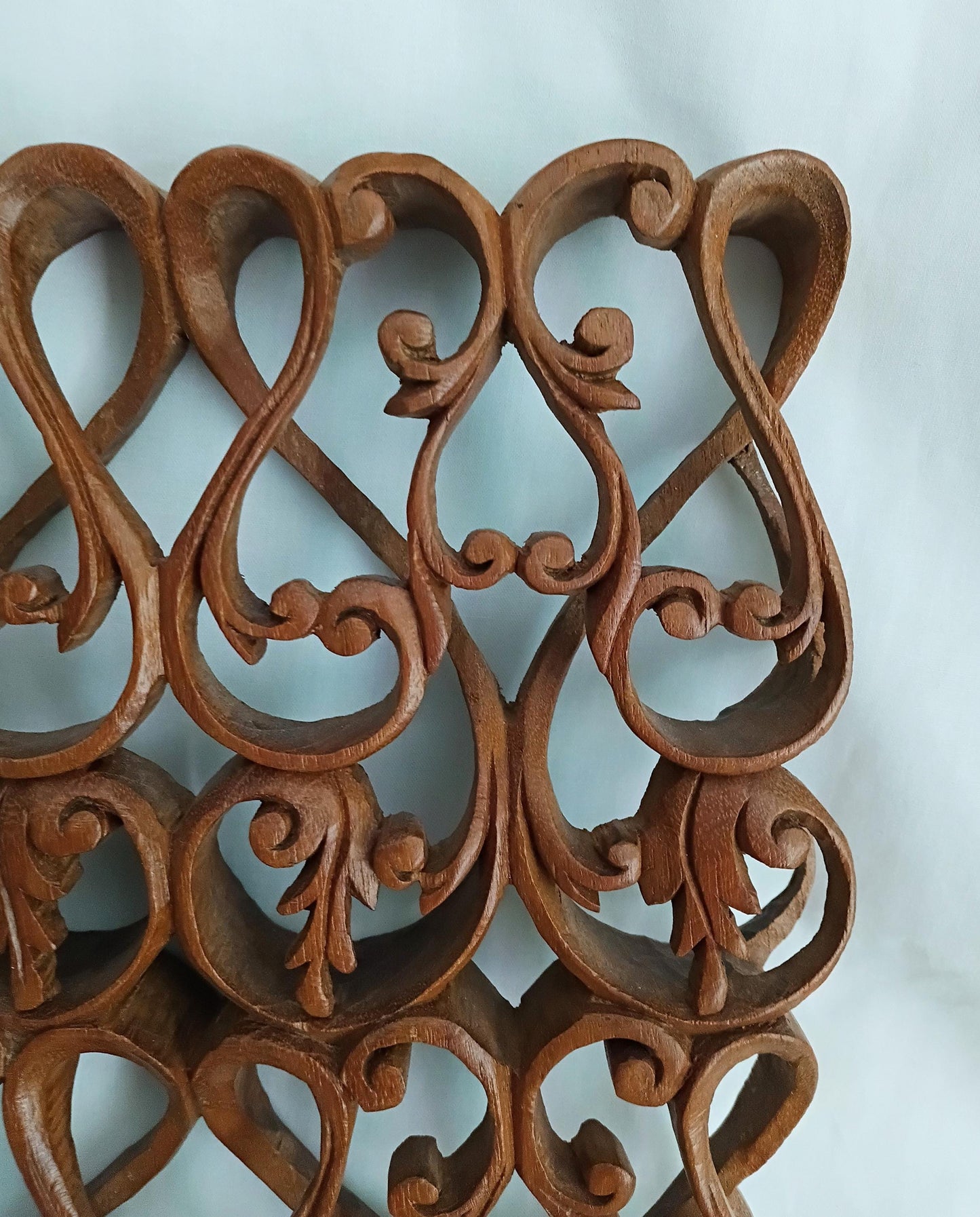 Intricately carved ethnic wooden curved pattern wall plaque