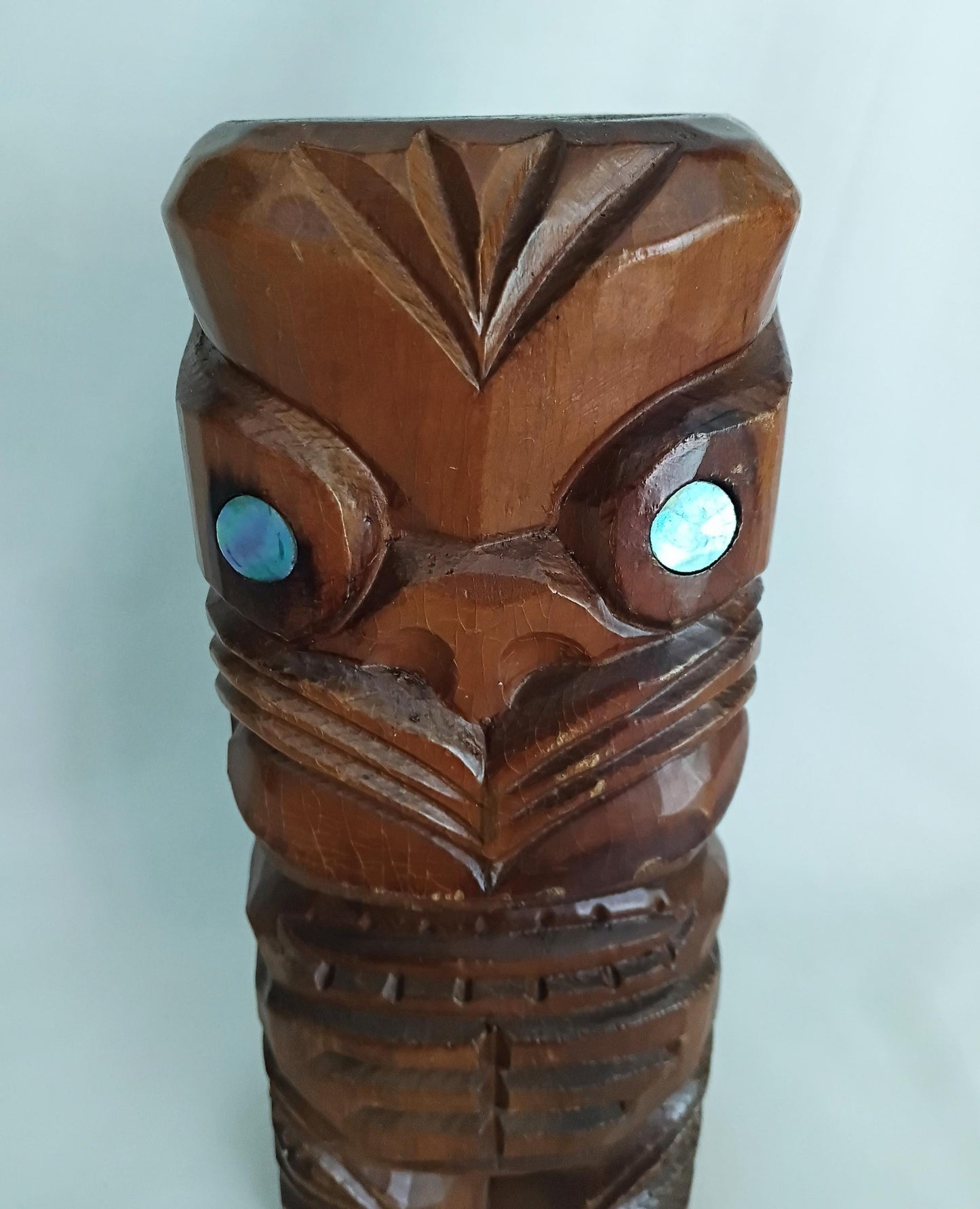 Hand carved wooden Tiki style statue set with abalone shell