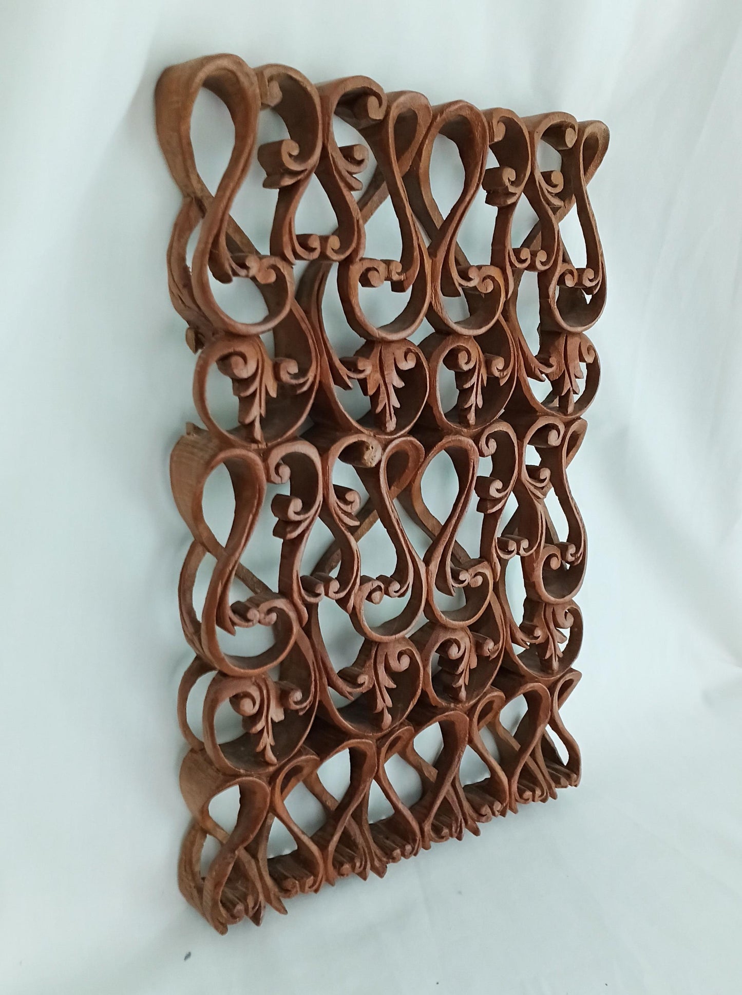 Intricately carved ethnic wooden curved pattern wall plaque