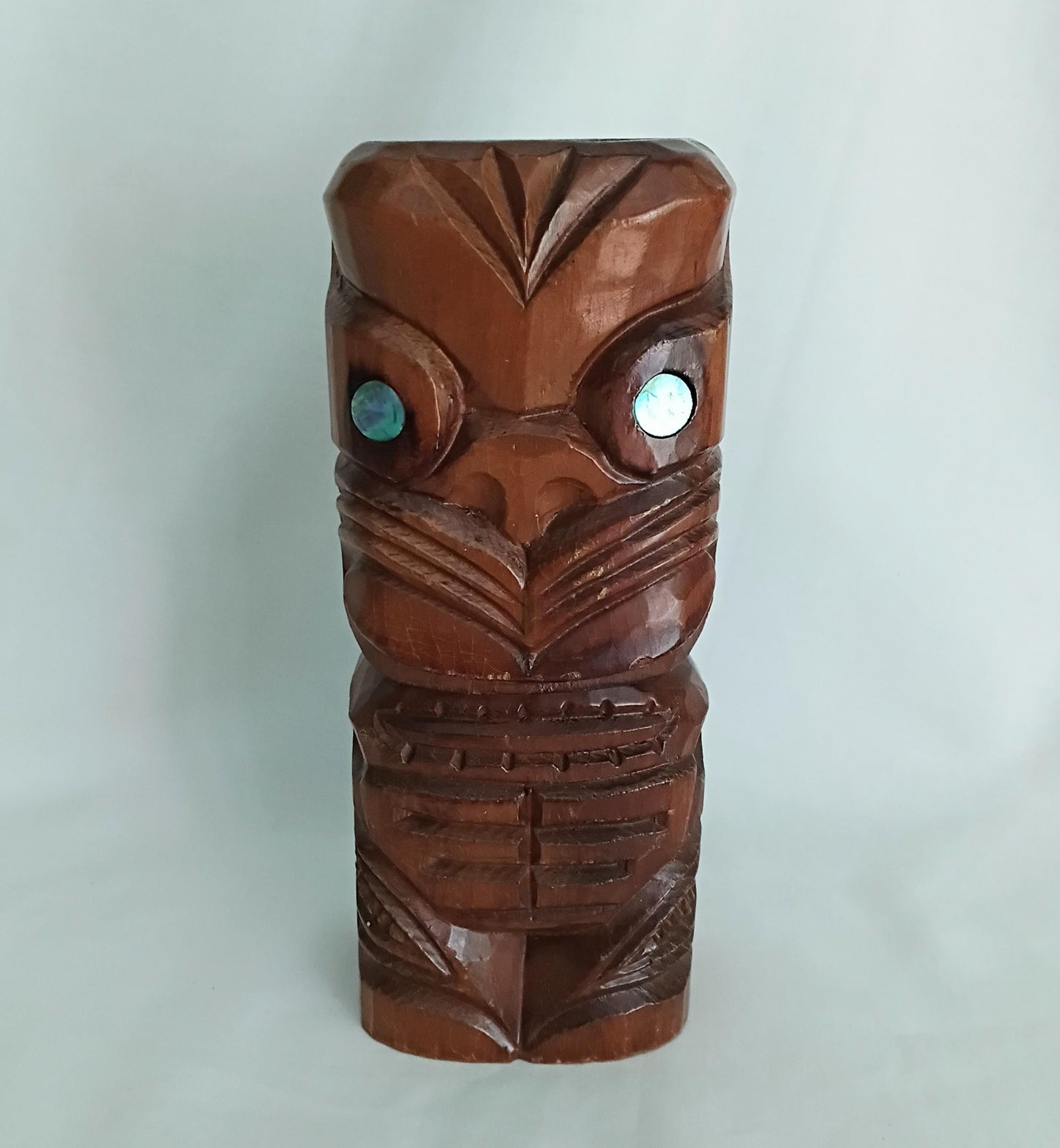 Hand carved wooden Tiki style statue set with abalone shell