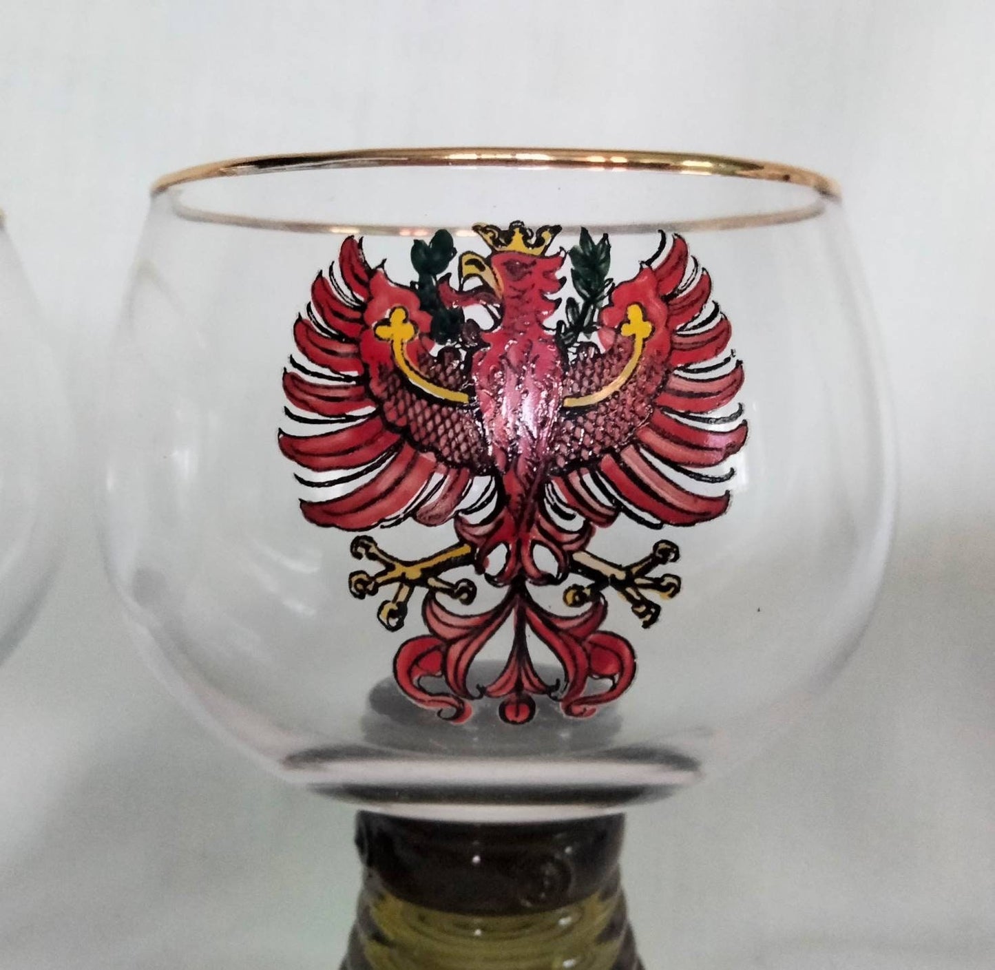 1970s pair of red phoenix design green glass beehive stem wine glasses