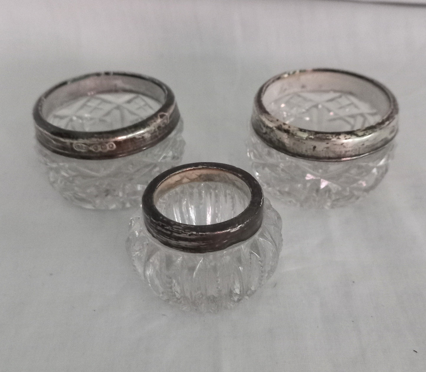 Pair Of Antique Hallmarked Silver Rimmed Clear Cut Glass Salt Cellars London 1921 & another single salt