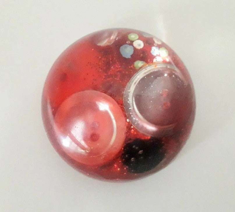Handmade resin paperweight inlaid with red vintage buttons and glitter