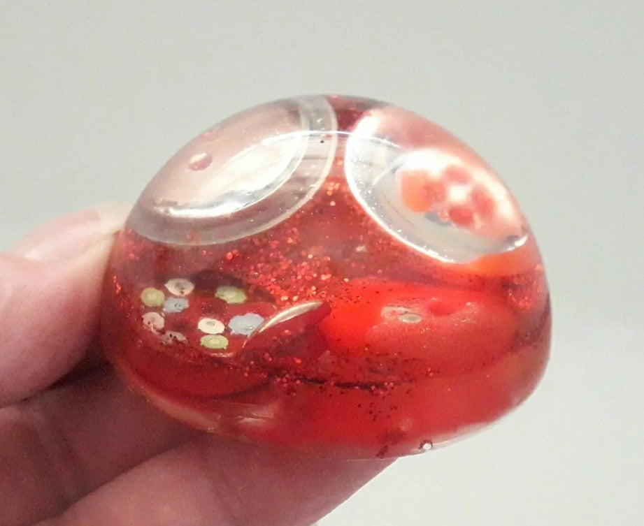 Handmade resin paperweight inlaid with red vintage buttons and glitter