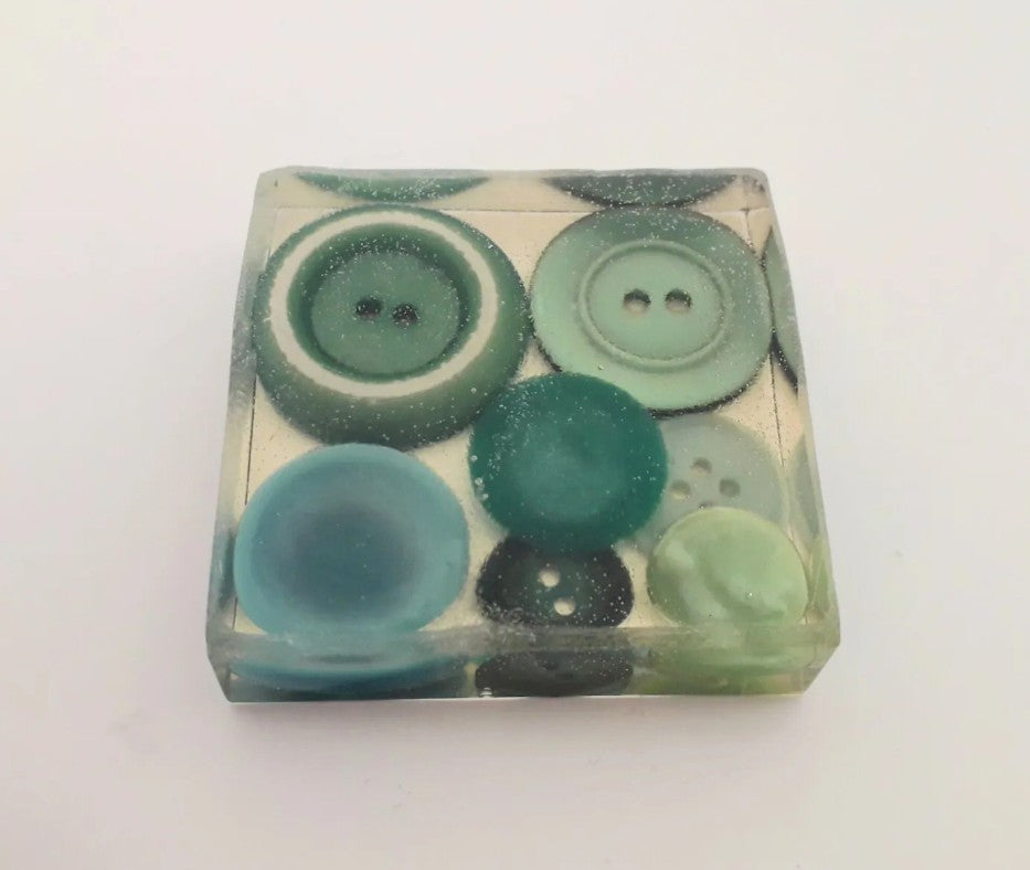 Handmade resin paperweight inlaid with green vintage buttons