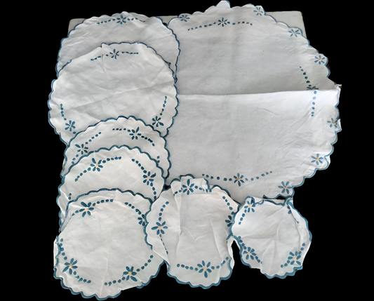 Set of 8 mid century hand made embroidered doilies with blue flowers