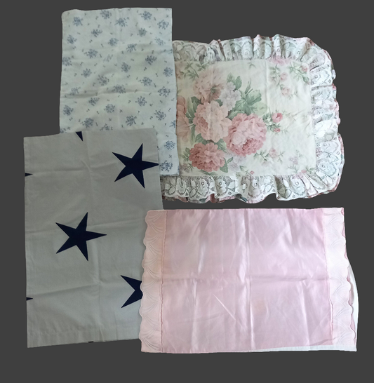 Four 1980s pillowcases in pink and blue with floral prints