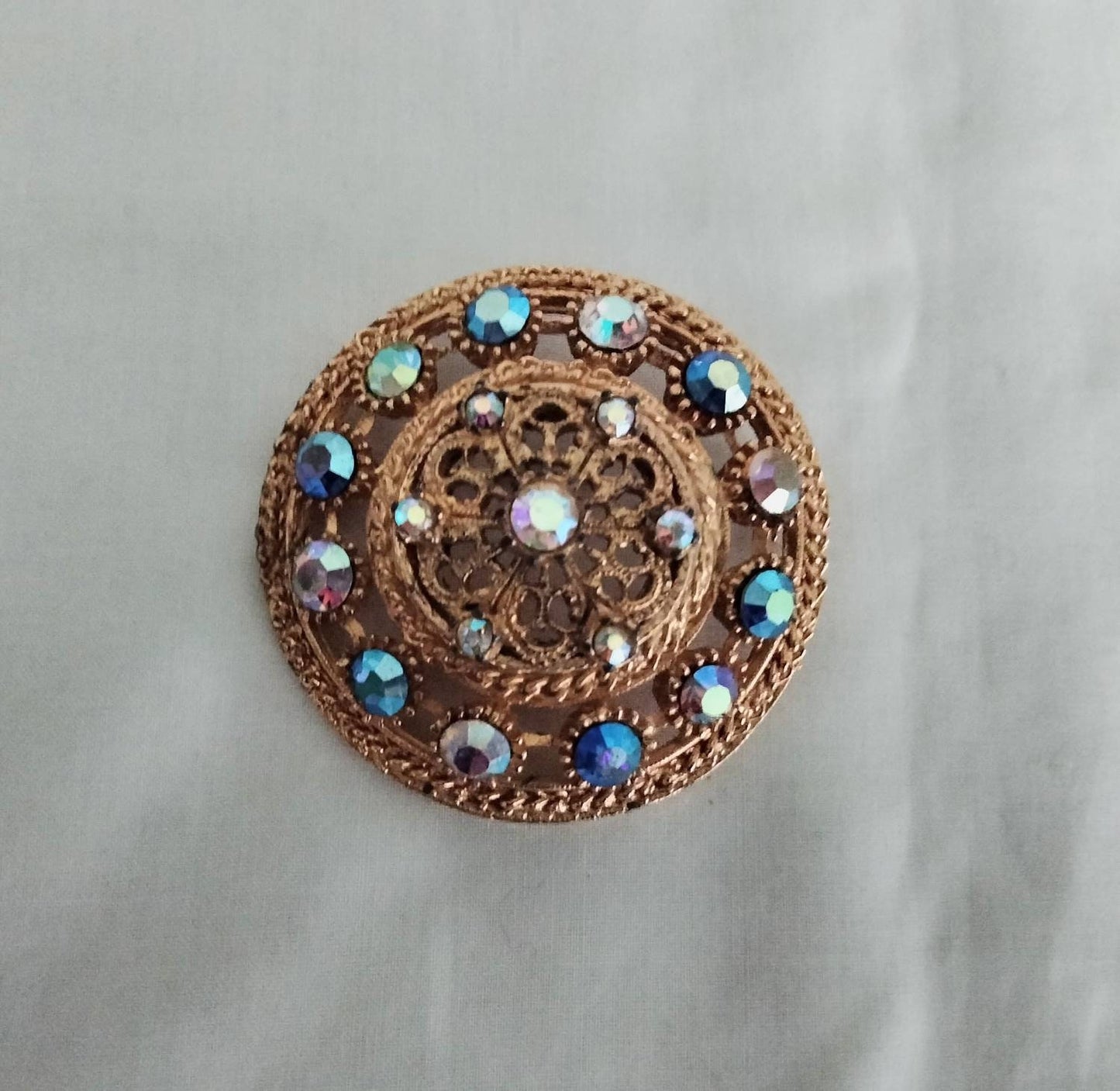 1950s goldtone & blue aurora borealis rhinestone large circular brooch
