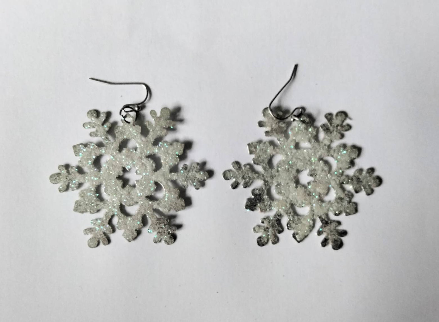 White & blue glitter snowflake dangly winter earrings