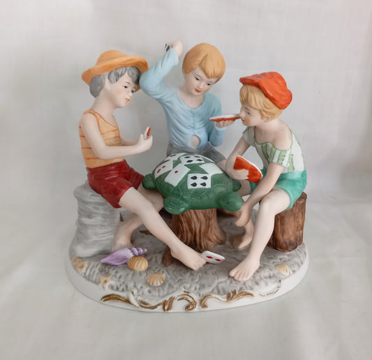Vintage kitsch ceramic figurine statue Of 3 Boys Playing Cards On A Turtle