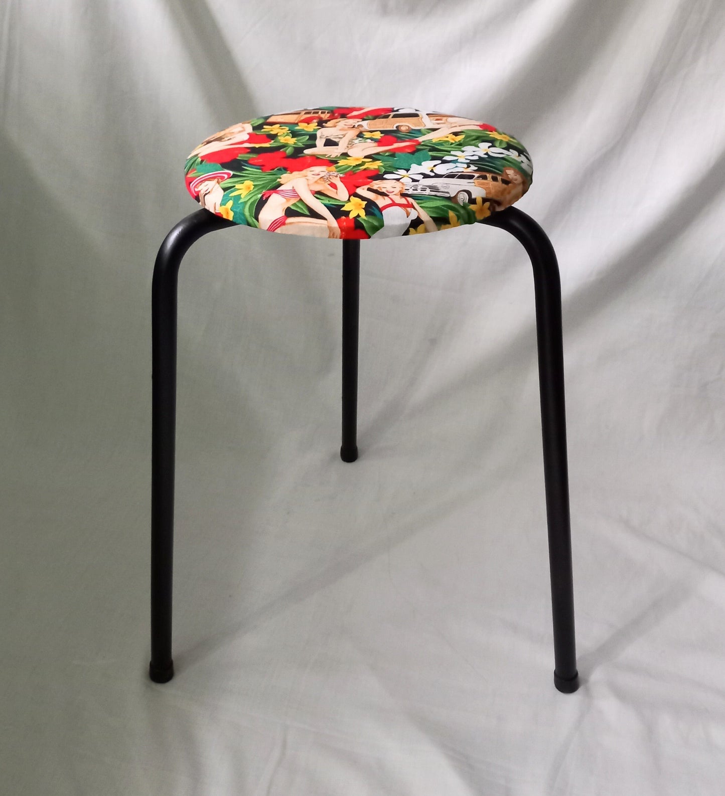 Mid century small stool reupholstered with red Hula Girls pin up girl fabric