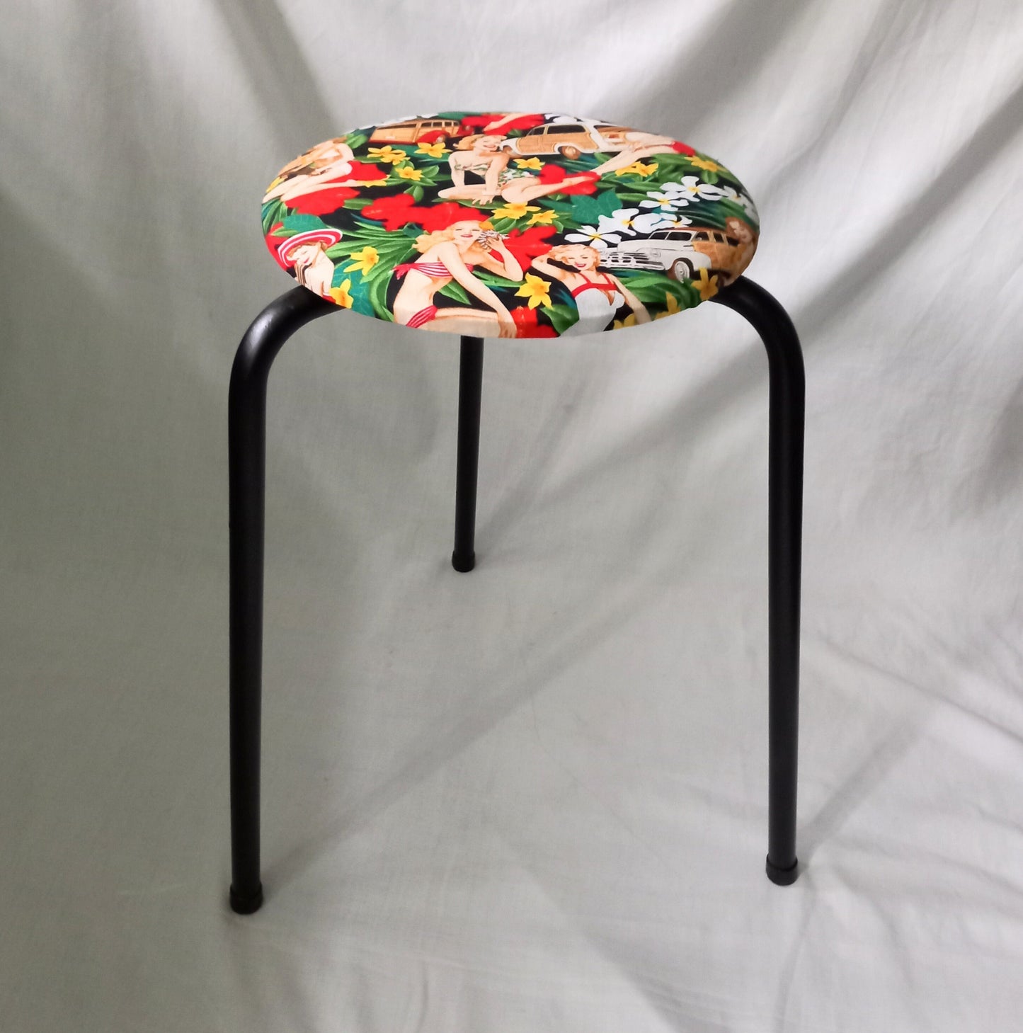 Mid century small stool reupholstered with red Hula Girls pin up girl fabric