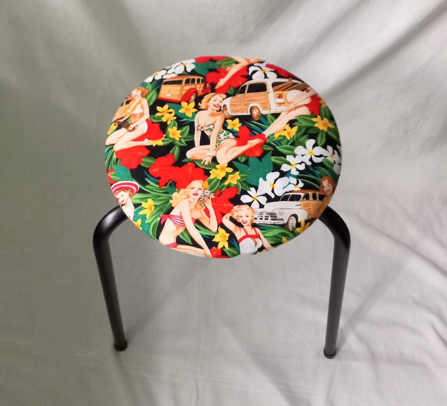 Mid century small stool reupholstered with red Hula Girls pin up girl fabric