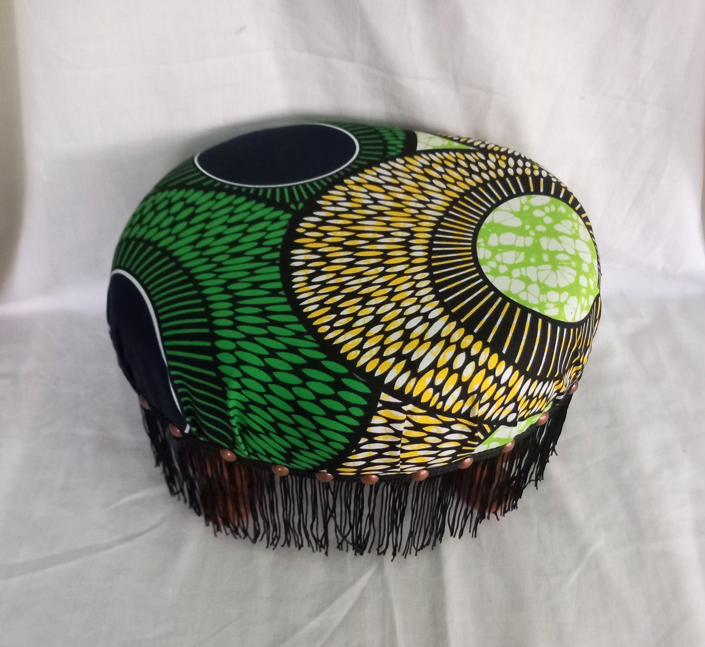 Vintage foot stool reupholstered with green & yellow African tribal print fabric