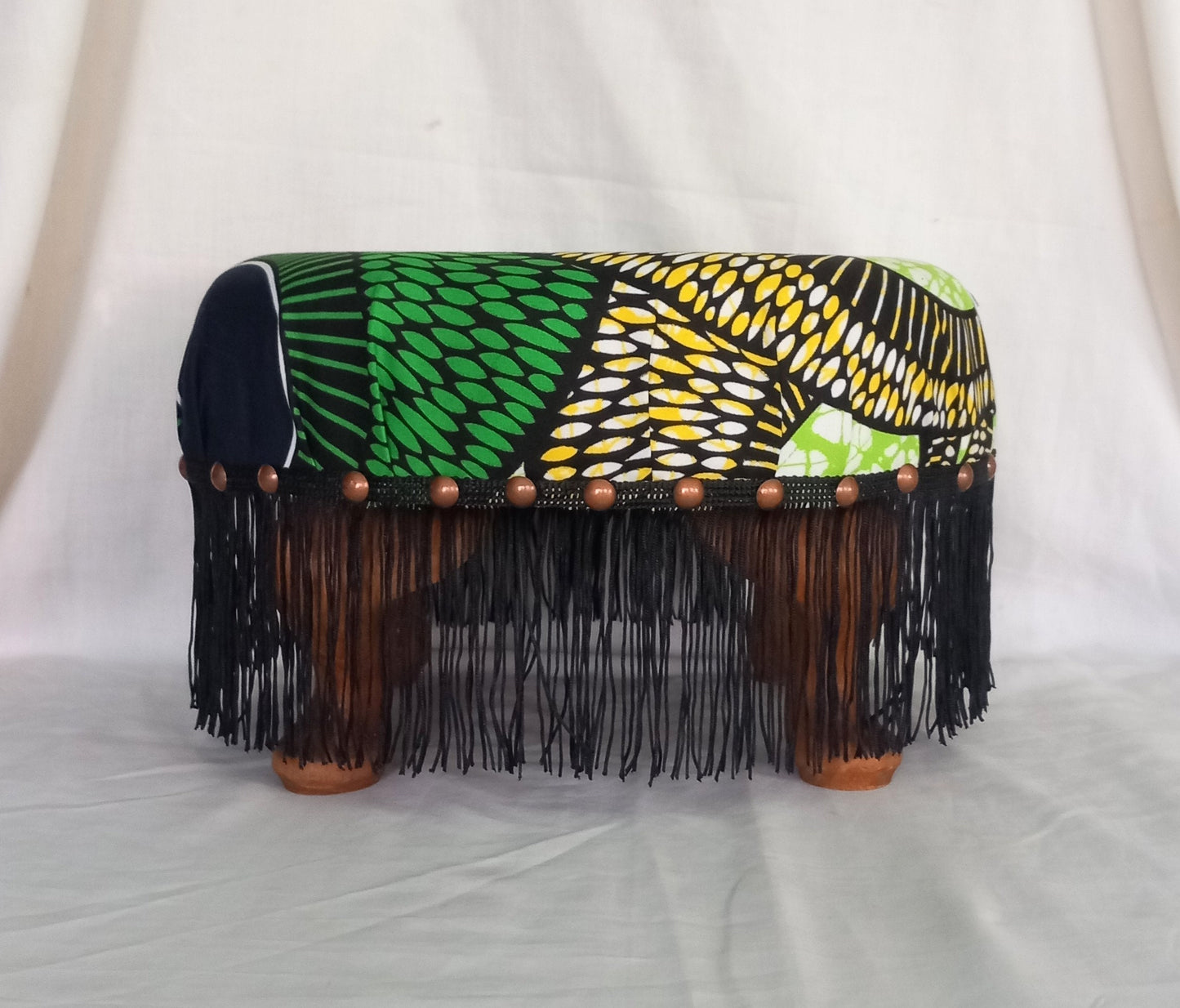 Vintage foot stool reupholstered with green & yellow African tribal print fabric