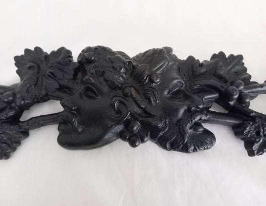 Vintage black cast iron moulding with Bacchus satyrs masks