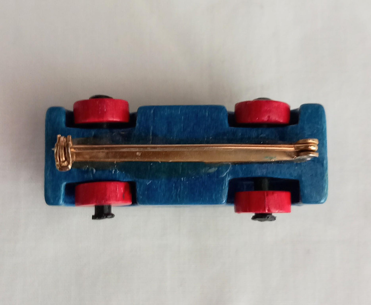 1960s hand made blue & red wooden car brooch with moving wheels