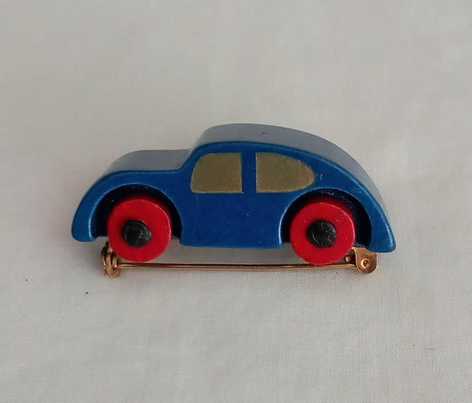 1960s hand made blue & red wooden car brooch with moving wheels